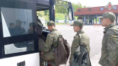 Russian younger POWs board bus in Belarus after release from Ukraine