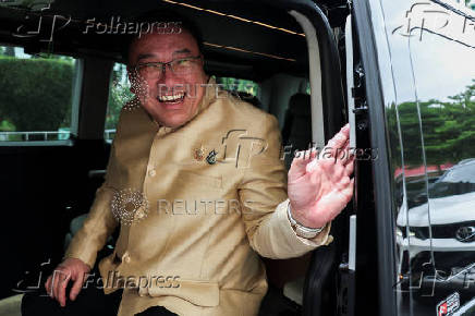 Thailand's Deputy Finance Minister Julapun Amornvivat reacts as he leaves the Government House after a cabinet meeting, in Bangkok