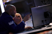 Traders work on the floor at the New York Stock Exchange, in New York City