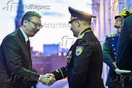 Serbian President Aleksandar Vucic shakes hands as he arrives for a meeting with Russian President Vladimir Putin at the Kremlin in Moscow
