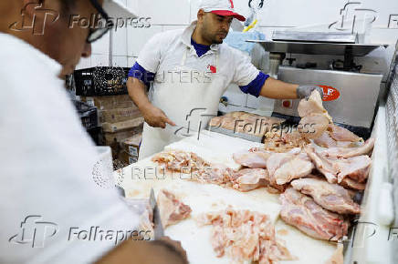Chicken vendors work in a market in Sao Paulo