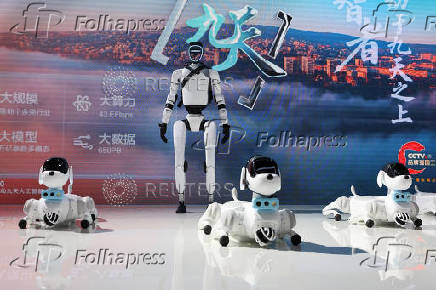 A humanoid robot and robot dogs are displayed at China Mobile booth during WAIC in Shanghai