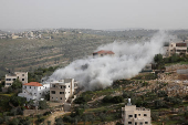 Smoke rises after the Israeli army blew up the house of a Palestinian assailant in Deir Ibzi town, near Ramallah