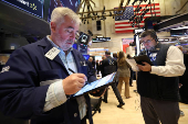 Traders work on the floor at the New York Stock Exchange, in New York City