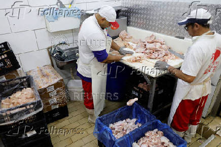 Chicken vendors work in a market in Sao Paulo