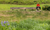 A man sits on a bench in a park in Moscow