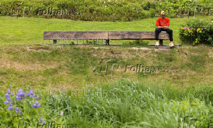 A man sits on a bench in a park in Moscow