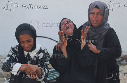 Mourners attend the funeral of Palestinians who were killed, according to medics, in Israeli fire, at Al-Shifa hospital, in Gaza City