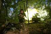 A Ukrainian serviceman fires a howitzer towards Russian troops at a front line in Zaporizhzhia region