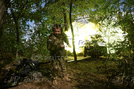 A Ukrainian serviceman fires a howitzer towards Russian troops at a front line in Zaporizhzhia region