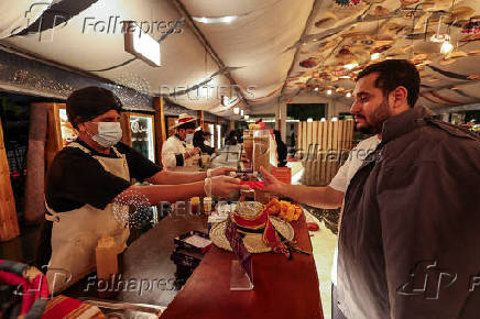A Saudi man sells local food to visitors at a Cultural and Heritage Festival in downtown Abha, Saudi Arabia