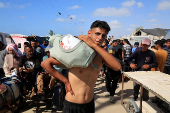Palestinians seeking aid gather near an aid distribution site run by the U.S.-backed Gaza Humanitarian Foundation, in Rafah