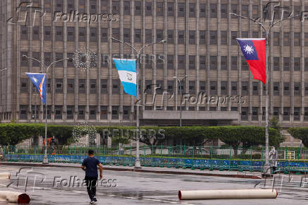 The national flags of Taiwan and Guatemala flutter outside the Presidential Office Building in Taipei