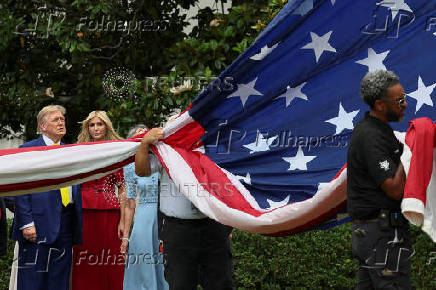 A U.S. flag is raised on a new flagpole installed on the South Lawn of the White House in Washington