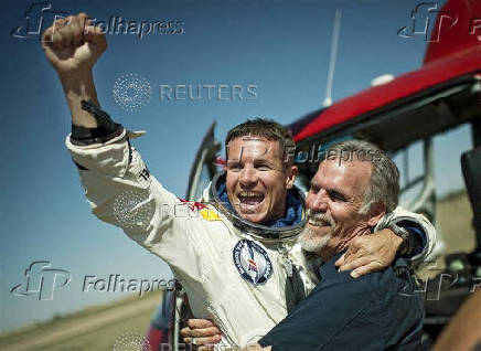 Pilot Felix Baumgartner of Austria and Technical Project Director Art Thompson of the Unites States celebrate after successfully completing the final manned flight for Red Bull Stratos in Roswell
