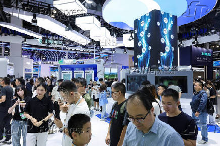People visit Tencent booth during WAIC in Shanghai