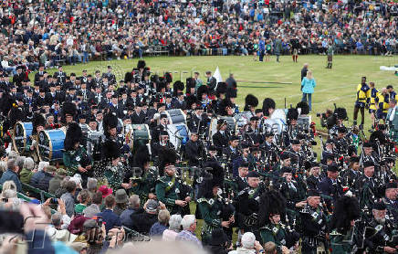Members of a Pipe band march during the Braemar Royal Highland Gathering at the Princess Royal and Duke of Fife Memorial Park in Braemar