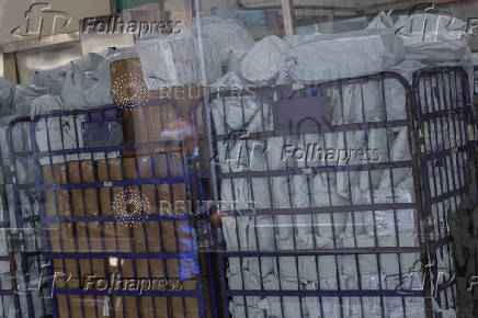Parcels await processing in a post office, as Hong Kong Post stops certain U.S.-bound shipments since April 27 due to new U.S. tariff rules, in Hong Kong