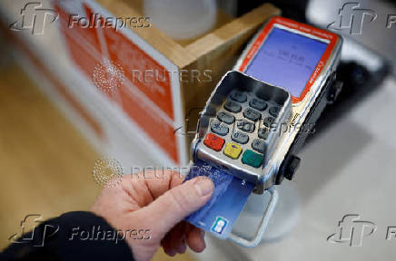 FILE PHOTO: Illustration of a credit card on a payment terminal