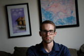 Ian Morgan, an employee at the National Institute for General Medical Sciences, sits for a portrait in Bethesda, Maryland