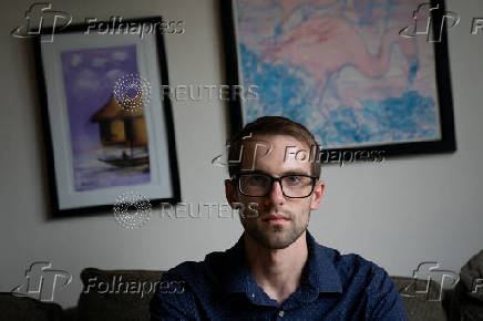 Ian Morgan, an employee at the National Institute for General Medical Sciences, sits for a portrait in Bethesda, Maryland