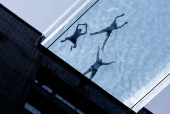 People swim in the Sky Pool during hot weather in London