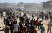 Palestinians gather to receive aid supplies amid a hunger crisis, in Beit Lahia