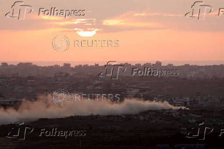 Smoke rises from Gaza as the sun sets, as seen from the Israeli side of the Israel-Gaza border