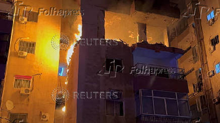 Fire burns at a building floor following an Israeli strike, in which the Israeli military said, it killed Hamas commander Hassan Farhat, in Sidon