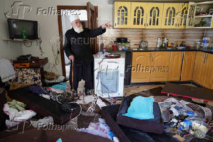 A Druze resident of Al-Soura al-Kubra, Salman Olaiwi, inspects his damaged home