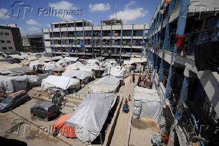 Palestinians displaced by the Israeli military offensive shelter in tents in a UNRWA school, in Gaza