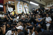 Reporters photograph the press conference where Chan Po-ying, chair of Hong Kong?s League of Social Democrats, along with party members announces the party?s dissolution amid China?s national security law, in Hong Kong