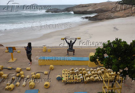 People work out in the Arpoador beach amid strong winds in Rio de Janeiro