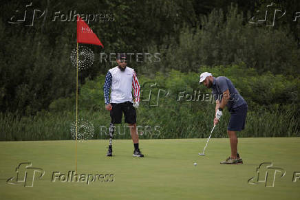 Ukrainian war veterans take part in a golf tournament outside of Kyiv
