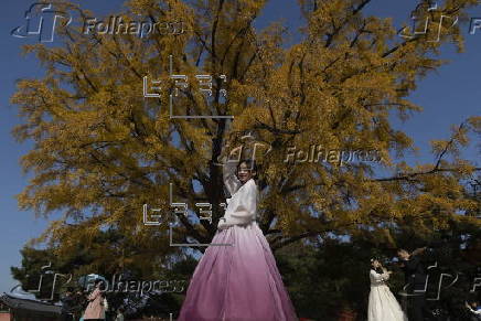 Tourists in Hanbok take selfies at Seoul’s Gyeongbokgung Palace