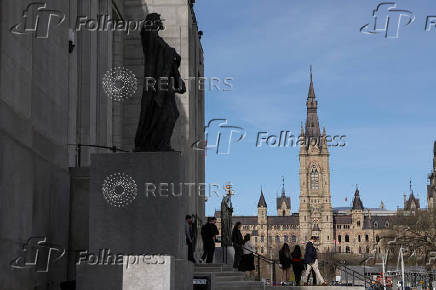 People walk next to the statues called Veritas (Truth) and Ivstitia (Justice), at the Supreme Court of Canada in Ottawa