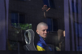 Ukrainian prisoners of war are seen in a bus as they return after a swap in an undisclosed location in Ukraine