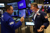 Traders work on the floor of the NYSE in New York
