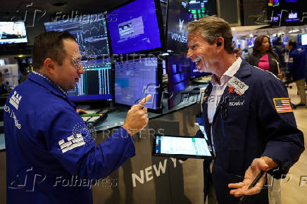 Traders work on the floor of the NYSE in New York