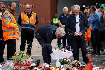 Fans pay their respects outside Anfield Stadium, on the day of the funeral of Liverpool soccer player Diogo Jota in Portugal, in Liverpool