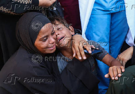 Mourners react during the funeral of Palestinians killed by Israeli fire while trying to receive aid, in Khan Younis