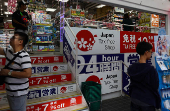 People shop inside a tax free drug store at Ameyoko shopping district in Tokyo