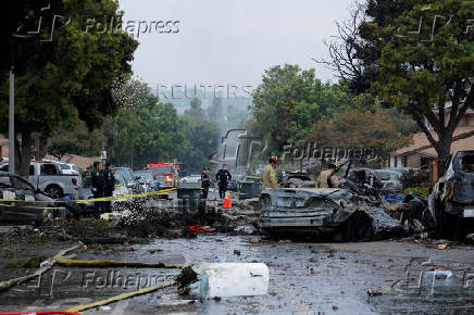 Crash scene after a civilian aircraft went down in a neighborhood, in San Diego