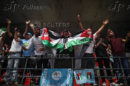 Jordanians celebrate a goal scored by their national football team against Oman as Jordan qualified for the World Cup for the first time after 3-0 win over Oman, in Amman