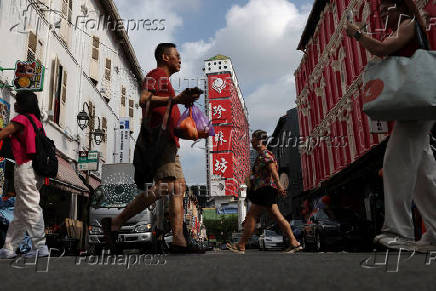 Workers paint the facade of People?s Park Complex, a residential building popular with Instagrammers, in Chinatown, Singapore