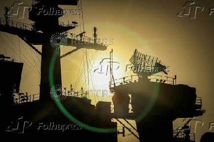 FILE PHOTO: The sun sets behind the U.S. Navy aircraft carrier USS Abraham Lincoln, in Arabian Sea