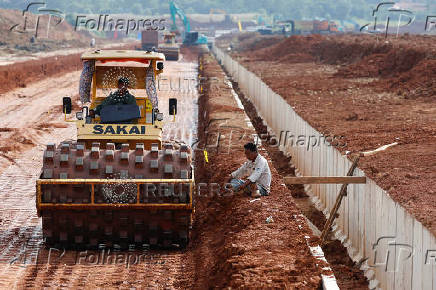 A worker operates a sheepsfoot roller at Subang Smartpolitan area in Subang