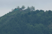 India's flag is seen outside an Observation Post on the mountain, as seen from the Chakothi Village