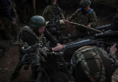 Servicemen fire a howitzer towards Russian troops at a position on front line in Donetsk region