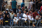 Palestinians gather to receive aid supplies amid a hunger crisis, in Beit Lahia
